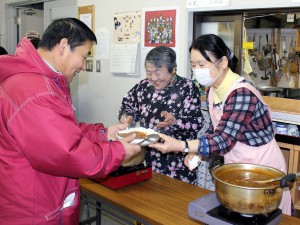 # 食事提供中の1コマ。おいしそうな料理を前にすると、お越しになった方も、ボランティアも、思わず笑顔がこぼれます